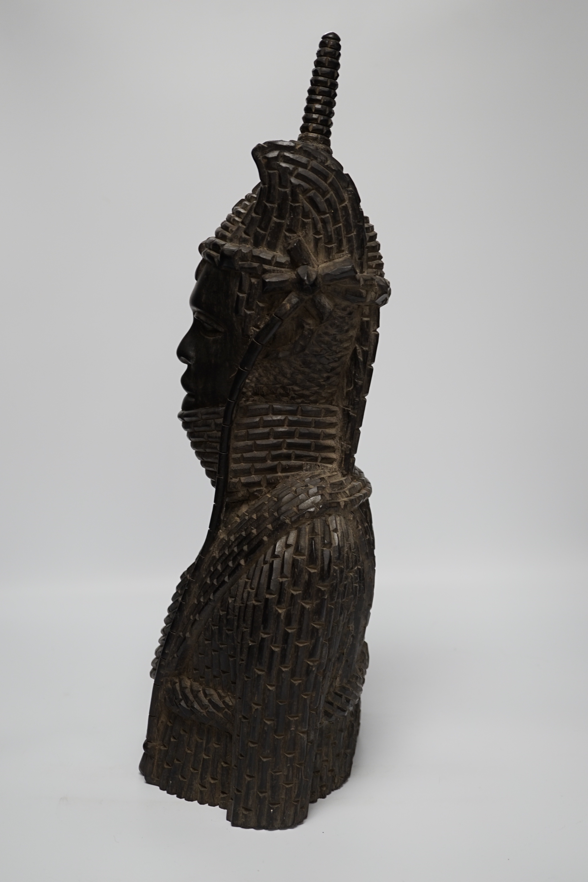 A heavy African ebony carved bust of a warrior, in Benin style, 48cm high